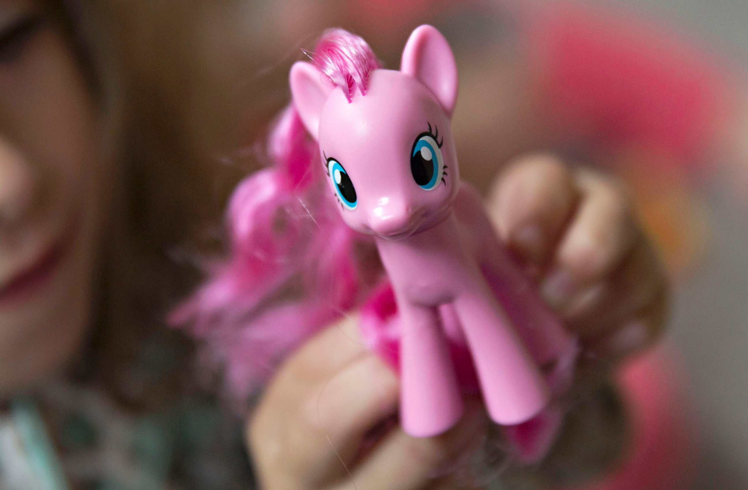 PHOTO: A young girl plays with a Hasbro Inc. My Little Pony character in Tiskilwa, Illinois, July 16, 2015.
