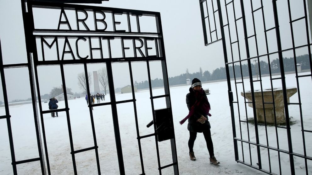 A visitor walks past an inscription that reads: "Arbeit Macht Frei," which means "Work Leads To Freedom," at a gate at the Sachsenhausen concentration camp memorial on Holocaust Memorial Day, Jan. 27, 2014 in Oranienburg, Germany.