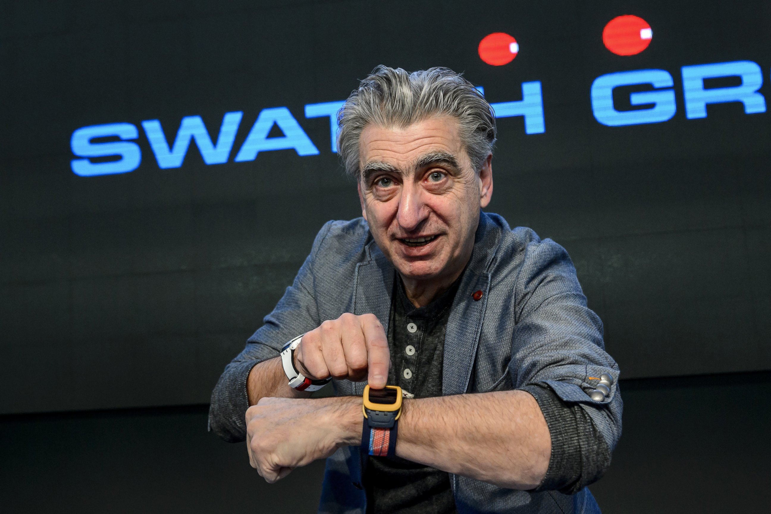 PHOTO: Swiss watchmaker Swatch Group CEO Nick Hayek shows the new Swatch Touch Zero One wrist watch during a press conference to present annual results of the worlds number one watchmaker on March 12, 2015 in Corgemont. 