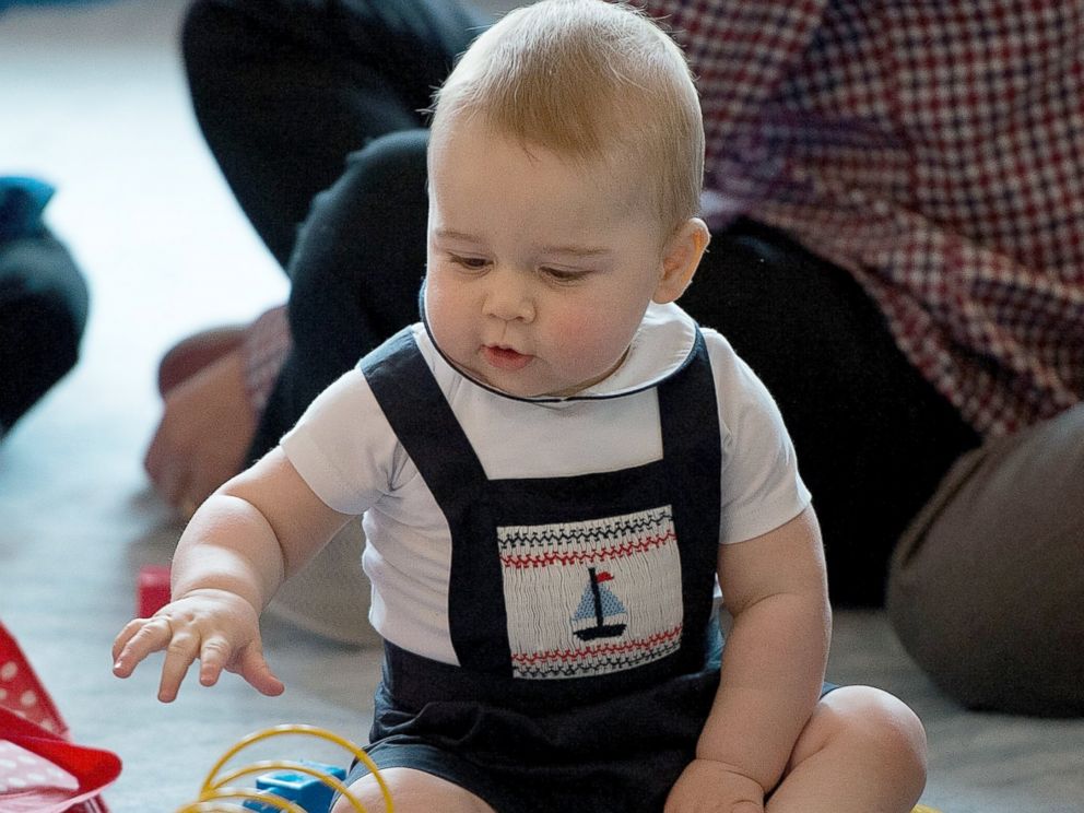 PHOTO: Prince George of Cambridge plays during a Plunket nurse and parents group visit at Government House, April 9, 2014, in Wellington, New Zealand.