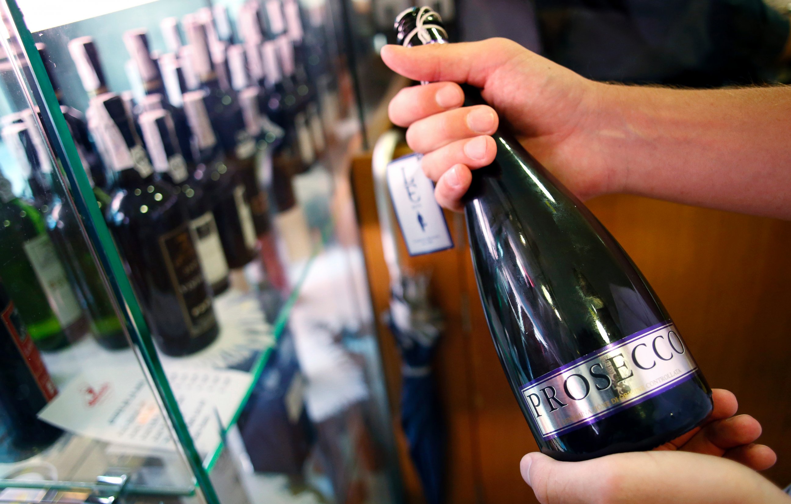 PHOTO: An Italian oenologist checks a bottle of Prosecco wine for authenticity at a food store in Treviso, Italy, Sept. 3, 2013.