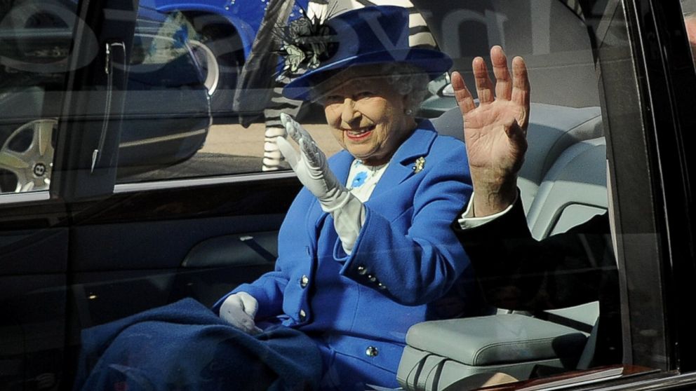 Queen Elizabeth II waves from her car as she leaves Investec Derby Day at Epsom Downs Racecourse in Epsom, England, June 2, 2012.