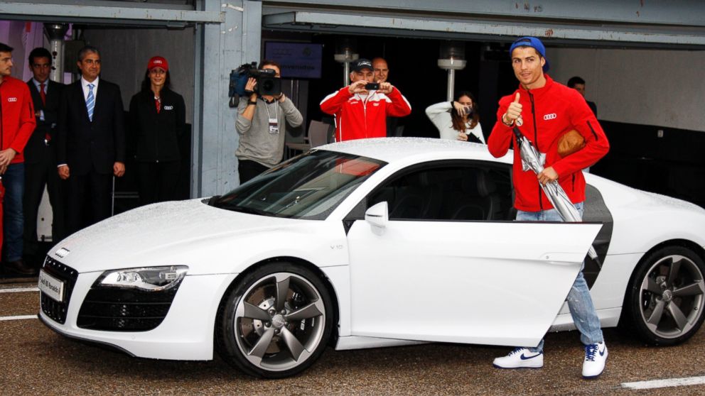 PHOTO: Real Madrid player Cristiano Ronaldo receives the keys of the new Audi car during the presentation of Real Madrid's new cars made by Audi at the Jarama racetrack in this Nov. 8, 2012, file photo in Madrid, Spain.  