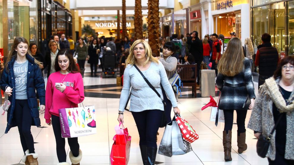 Shoppers carry their bags as they take advantage of Black Friday deals at Somerset Collection shopping mall, Nov. 29, 2013, Troy, Mich.