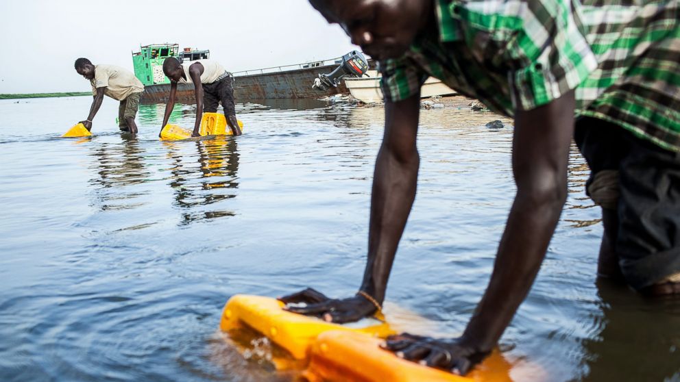 PHOTO: Young men load water from the Nile river into containers, Feb. 26, 2014 in Bor, South Sudan. 