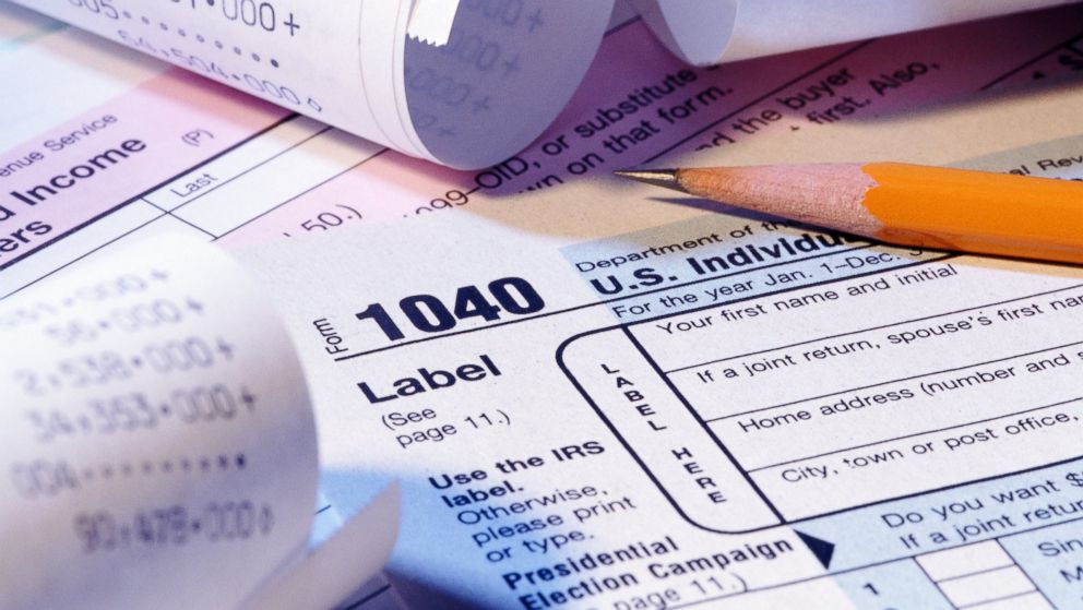 Tax forms, pencil and receipts are seen in this undated file photo.