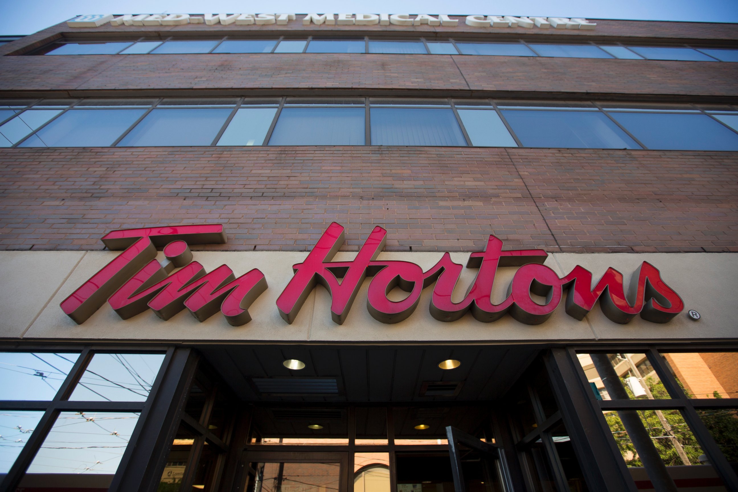 PHOTO: Tim Hortons signage is displayed outside of a restaurant in Toronto, Ontario, Canada on Sept. 16, 2013. 