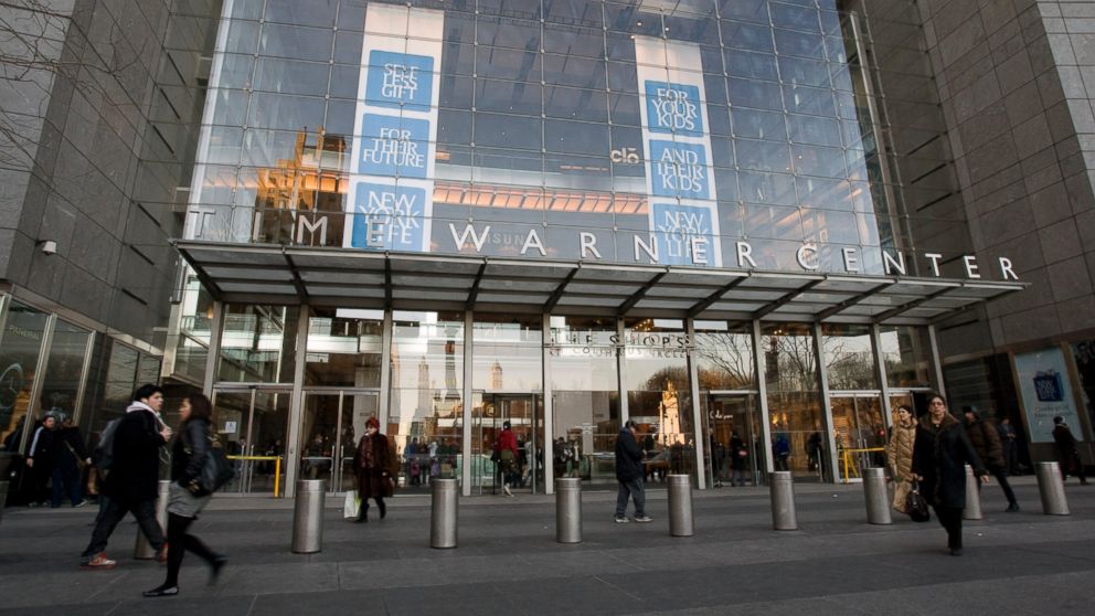 Pedestrians walk past the Time Warner Center, headquarters of Time Warner Inc., in New York, Feb. 4, 2009.