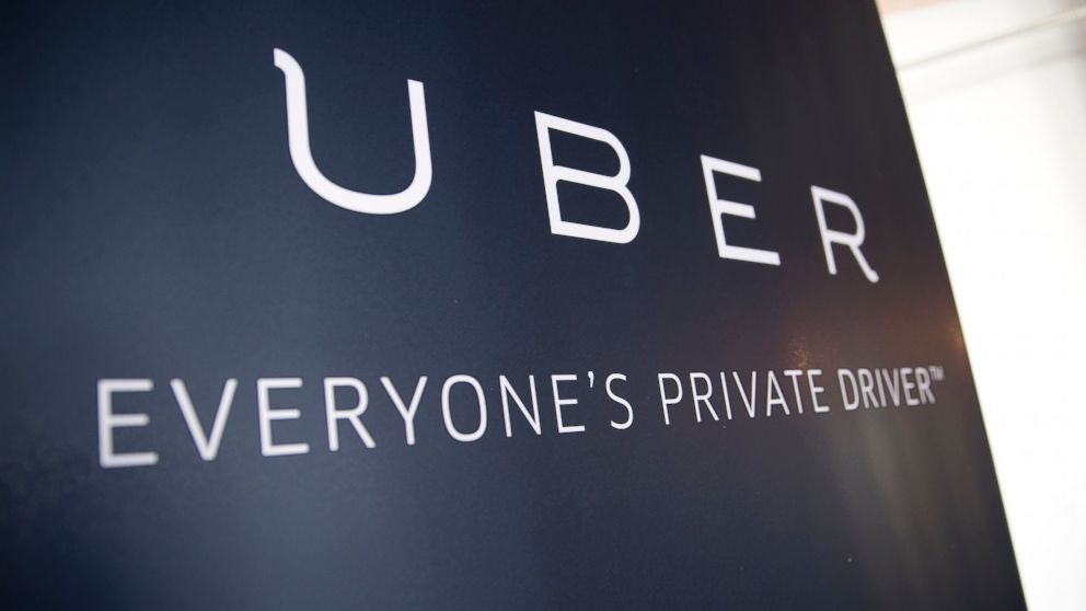 Uber Technologies Inc. signage stands inside the company's office in Washington, March 24, 2016.