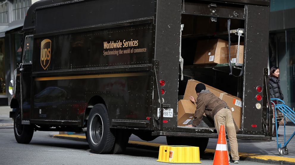 A UPS worker unloads packages from his truck in this Dec. 20, 2012 file photo in San Francisco, Calif.