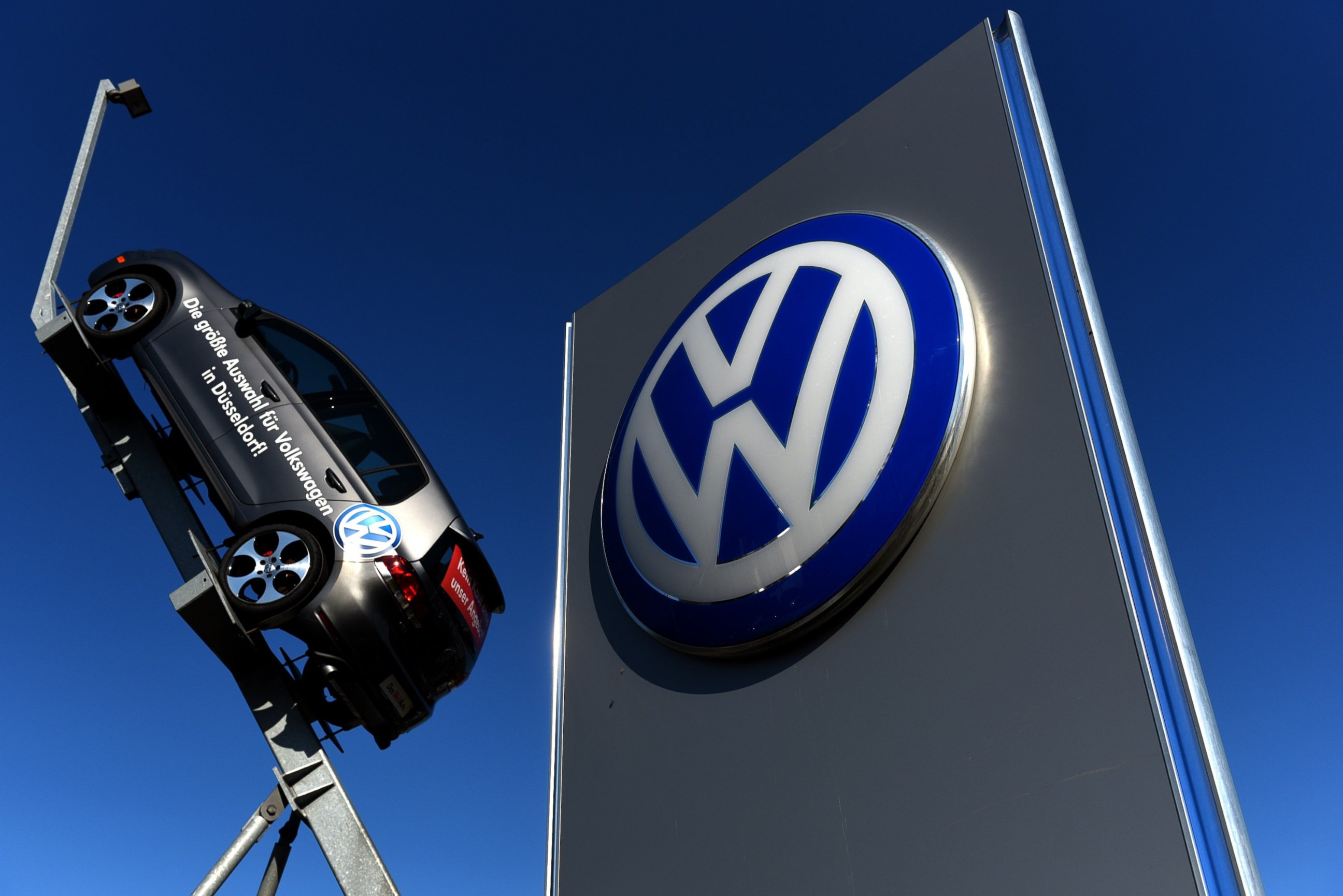PHOTO: A model and logo of German car maker Volkswagen are seen at the entrance to a VW branch in Duesseldorf, Germany on Sept. 28, 2015.  