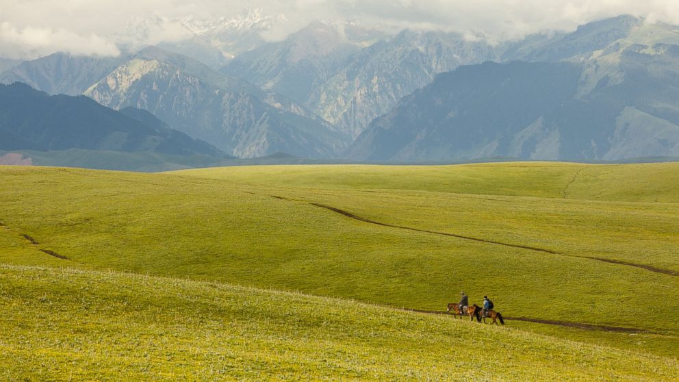 Horsemen travel through the Kalajun Mountain Area in Xinjiang.