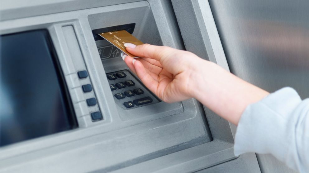 An undated stock photo of a woman using a cash machine. 