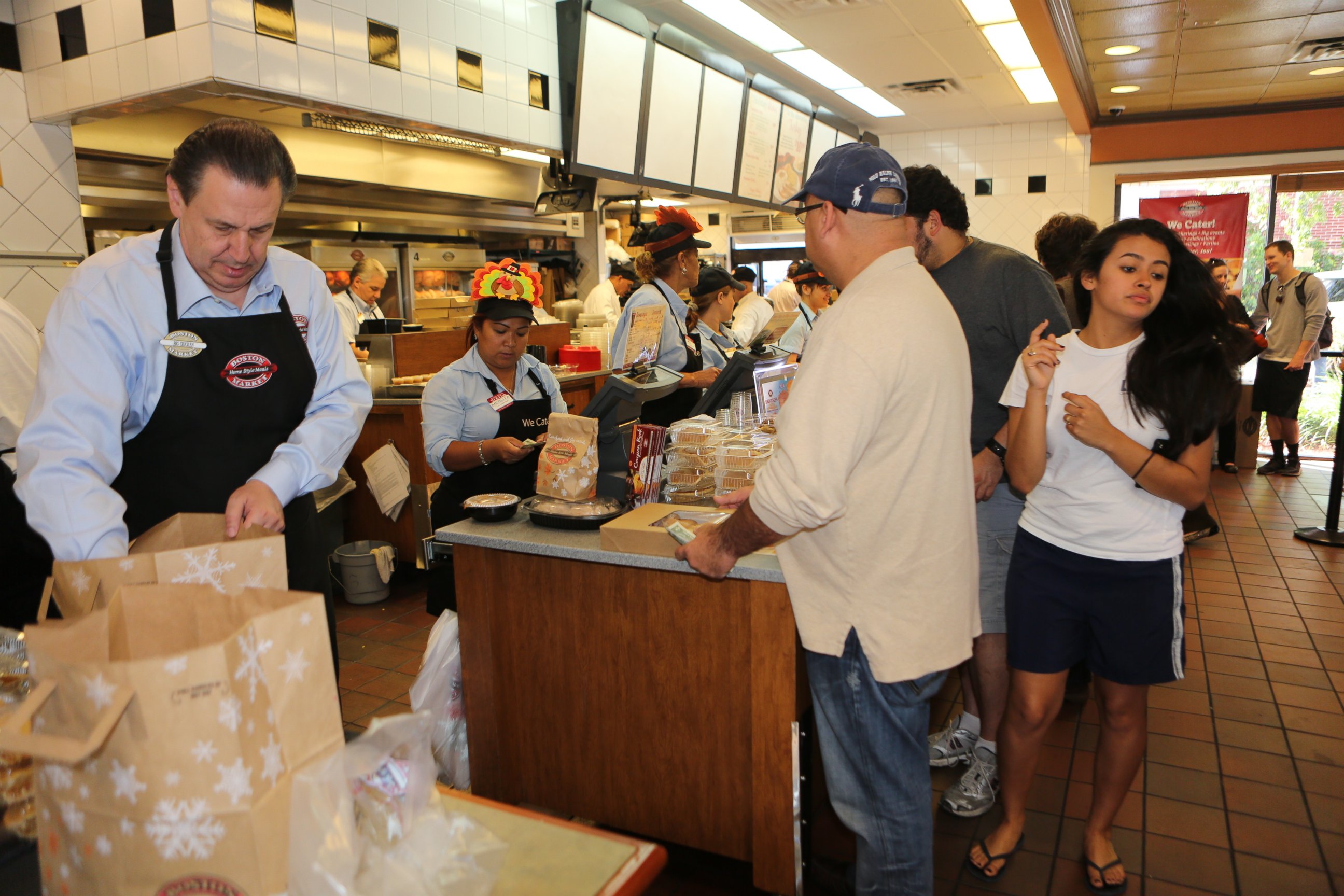 PHOTO: Boston Market CEO George E. Michael serves up Thanksgiving like the rest of company employees