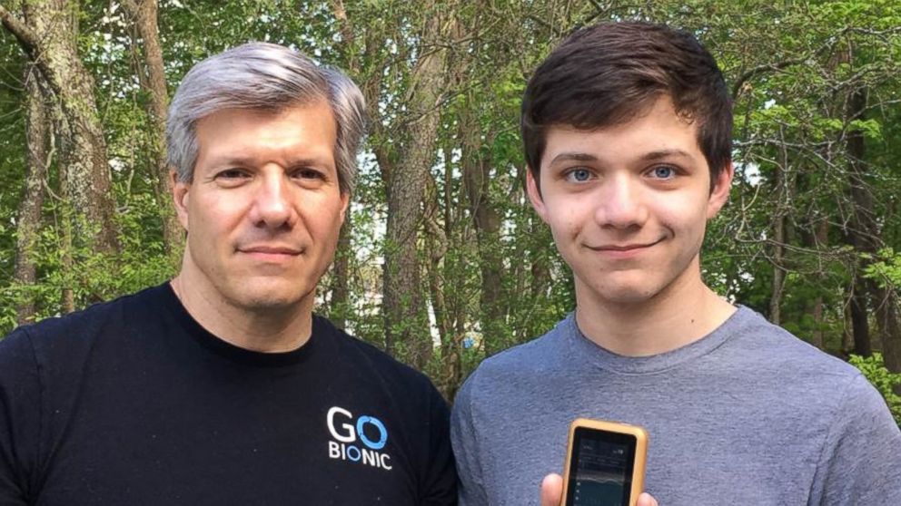 PHOTO: Edward Damiano, president of Beta Bionics, Inc., holds the company’s iLet bionic pancreas device, with his son David.