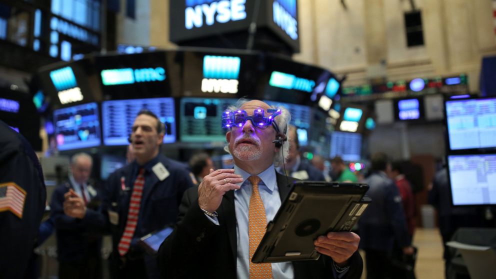 A trader wears glasses that say "2017" ahead of the new year on the floor of the New York Stock Exchange in Manhattan, New York City, Dec. 30, 2016.