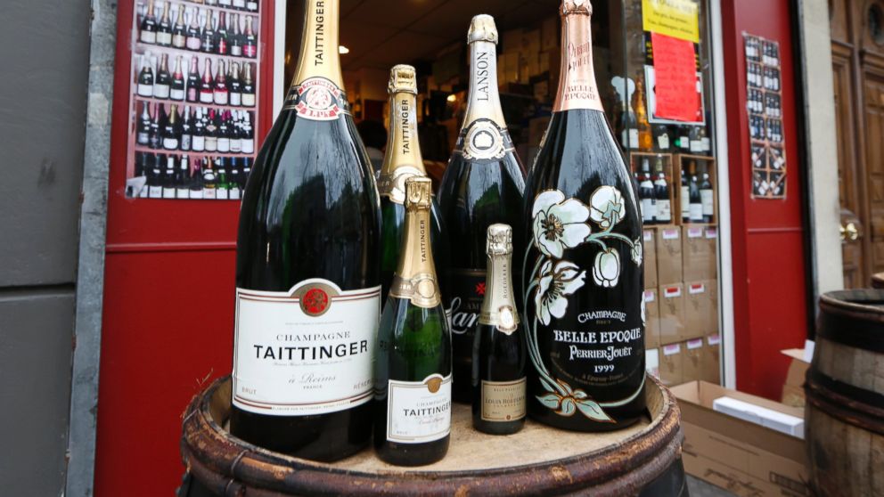 Various sizes of Champagne bottles are displayed in front of a wine shop in Paris, Dec. 21, 2012. 

