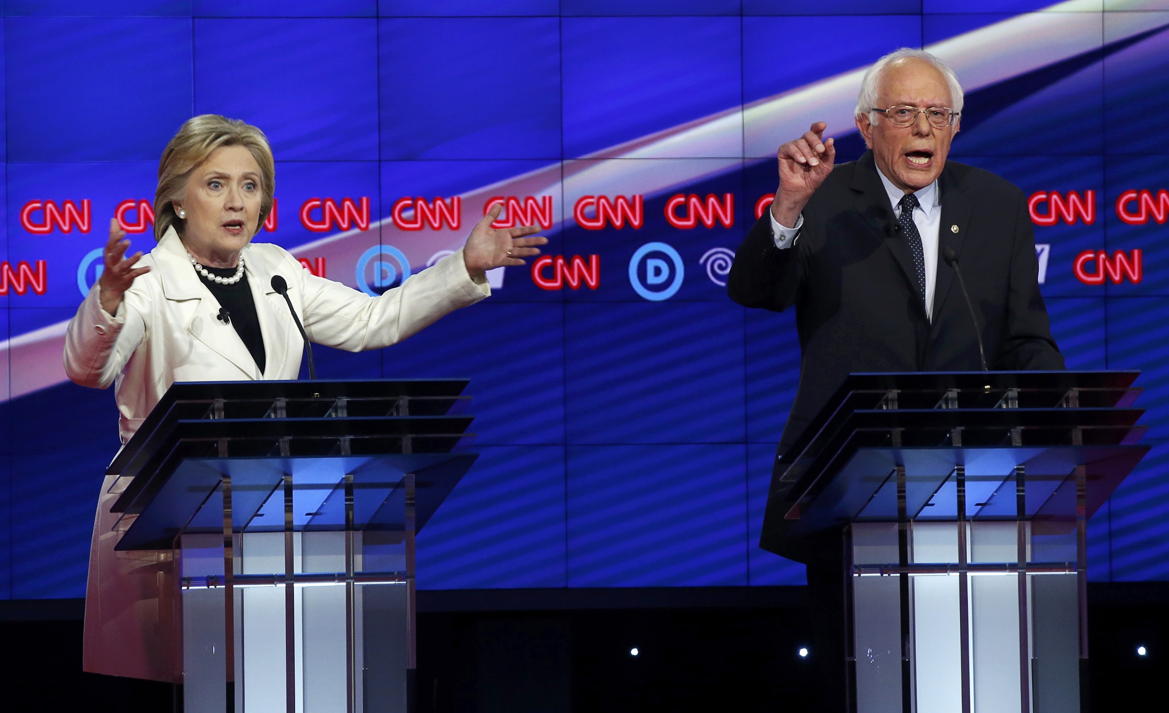 PHOTO: Democratic U.S. presidential candidates Hillary Clinton (L) and Senator Bernie Sanders speak simultaneously during a Democratic debate hosted by CNN and New York One at the Brooklyn Navy Yard in New York on April 14, 2016.  