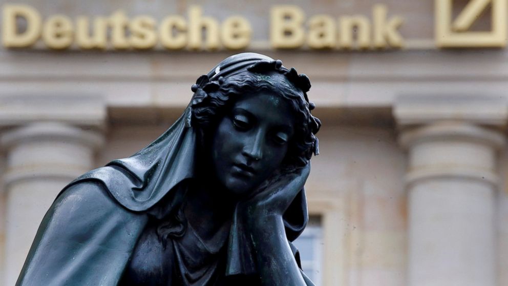 A statue is seen next to the logo of Germany's Deutsche Bank in Frankfurt, Germany, Jan. 26, 2016.    