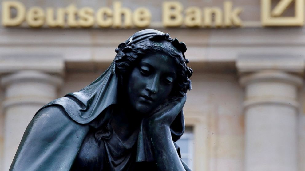 A statue is seen next to the logo of Germany's Deutsche Bank in Frankfurt, Germany, Jan. 26, 2016.   