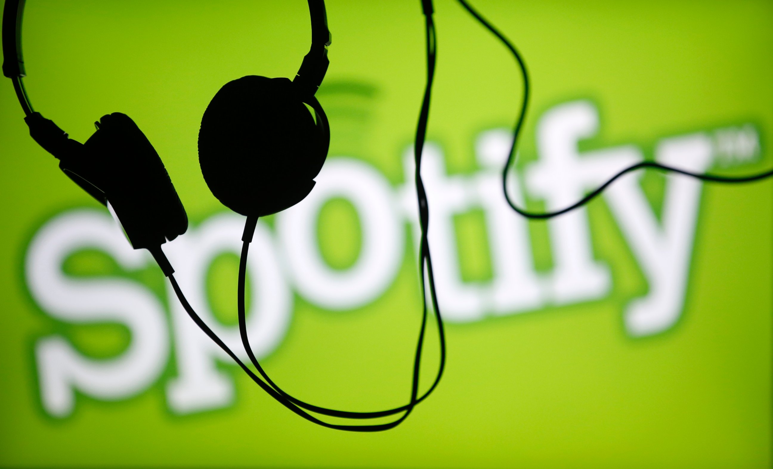 PHOTO: Headsets hang in front of a screen displaying a Spotify logo on it, in Zenica ,Bosnia and Herzegovina in this Feb. 20, 2014 file photo.