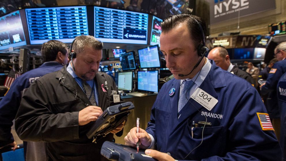 PHOTO: Traders work on the floor of the New York Stock Exchange October 1, 2014. 