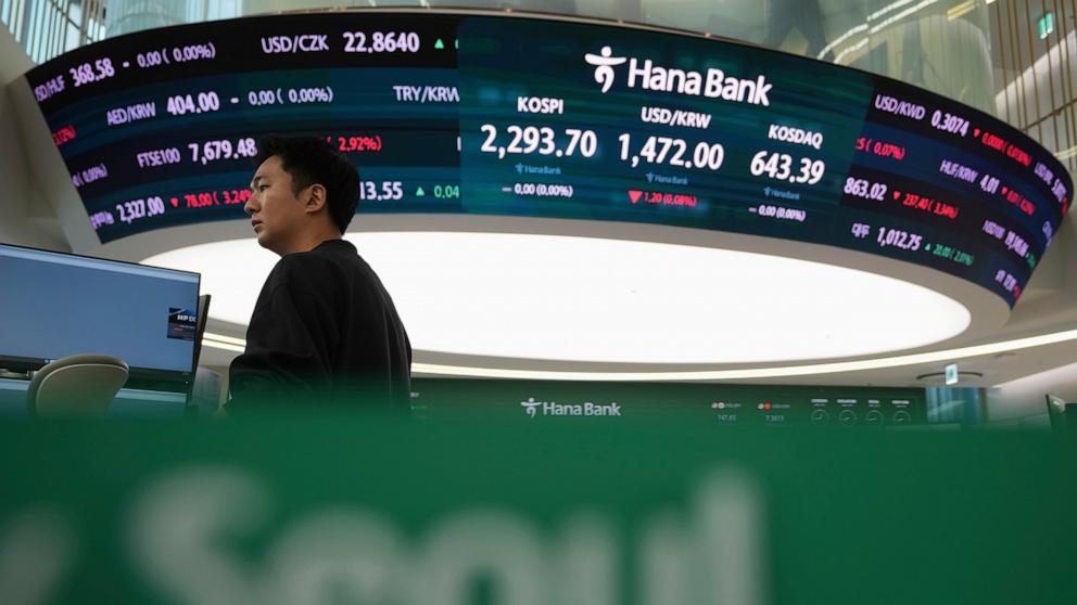 PHOTO: A currency trader is pictured near screens showing the Korea Composite Stock Price Index (KOSPI) and foreign exchange rates at a foreign exchange dealing room in Seoul, South Korea, on April 10, 2025.