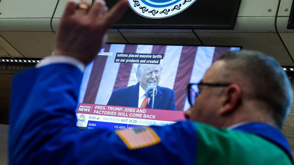 PHOTO: A futures-options trader works as a television displays President Donald Trump speaking on the floor at the American Stock Exchange at the New York Stock Exchange in New York City, on April 2, 2025.