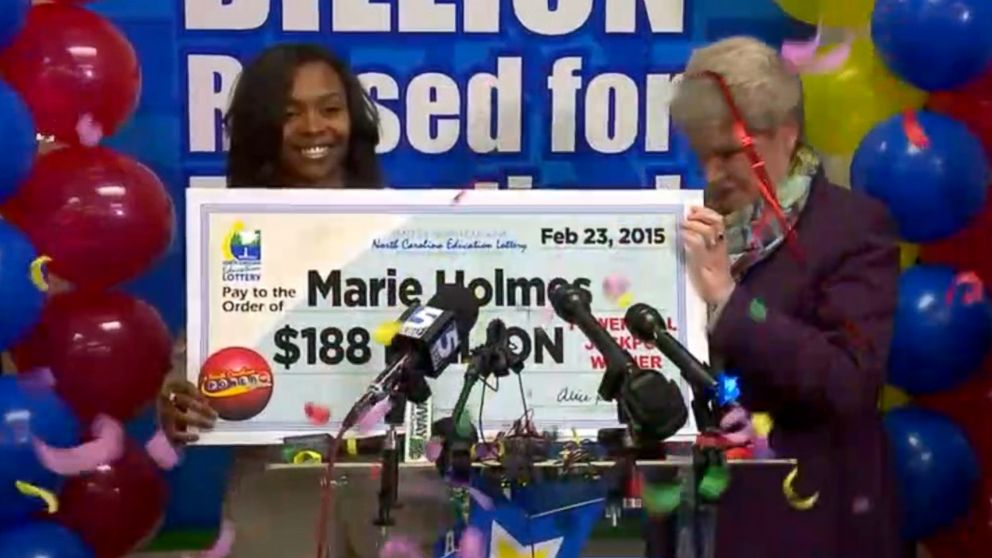 PHOTO: Marie Holmes accepts her $188 million dollar check for winning the North Carolina Powerball, Feb. 23, 2015.