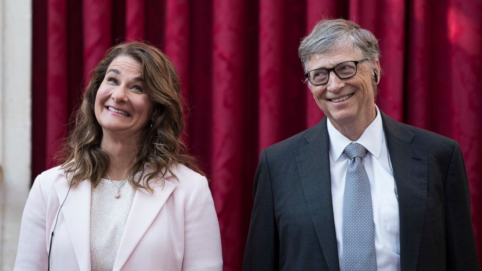 FILE - In this April 21, 2017, file photo, Philanthropist and co-founder of Microsoft, Bill Gates, right, and his wife Melinda react, prior to being awarded the Legion of Honour at the Elysee Palace in Paris. Bill Gates and Melinda French Gates will 