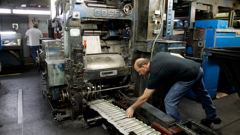 FILE - A pressman grabs a freshly printed paper off the press at the St. Louis Post-Dispatch's printing facility in Maryland Heights, Mo. in this Nov. 11, 2008 file photo. Newspaper publisher Lee Enterprises has rejected a takeover offer from the Ald