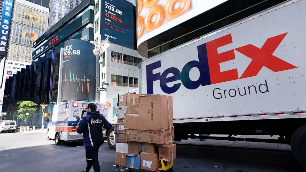 A FedEx driver delivers a cart of packages, Thursday, May 6, 2021, in New York. FedEx is getting hurt by the tight job market. The package delivery company said Tuesday, Sept. 21 that its costs are up $450 million in the most recent quarter, as it pa