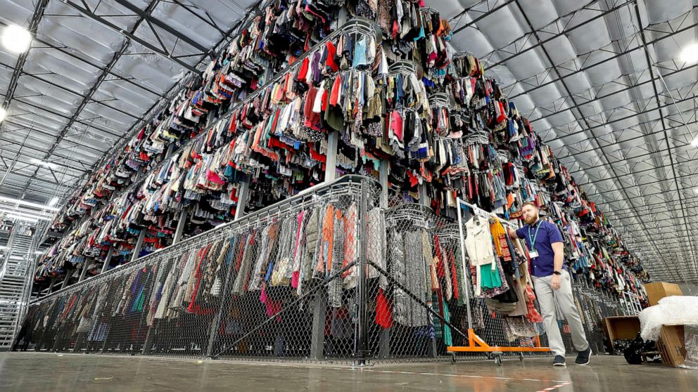 FILE - In this March 12, 2019, file photo thousands of garments are stored on a three-tiered conveyor system at the ThredUp sorting facility in Phoenix. Shares of ThredUp rose 30% in their stock market debut Friday, March 26, 2021, reflecting investo