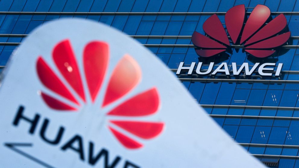 FILE - This Tuesday, Dec. 18, 2018, file photo, shows company signage on display near the Huawei office building at its research and development center in Dongguan, in south China's Guangdong province. A federal indictment accuses Huawei of stealing 
