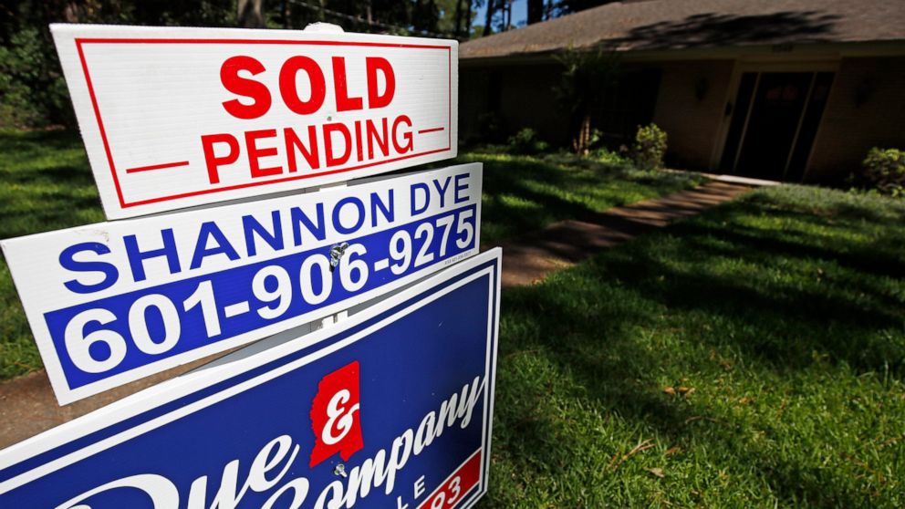 In this June 13, 2019, photo a house on the market has a "sold pending" sign fixed on the realtor's sign in northeast Jackson, Miss. On Thursday, June 27, the National Association of Realtors releases its May report on pending home sales, which are s