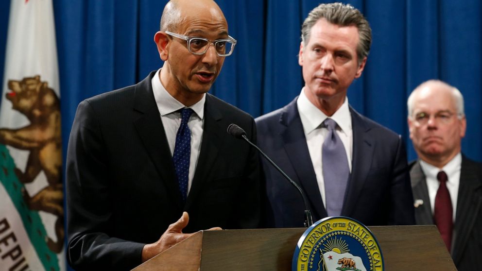 FILE - In this March 12, 2020, file photo Dr. Mark Ghaly, secretary of the California Health and Human Services, discusses the coronavirus as Gov. Gavin Newsom, center, listens at a news conference in Sacramento, Calif. Sacramento area officials were