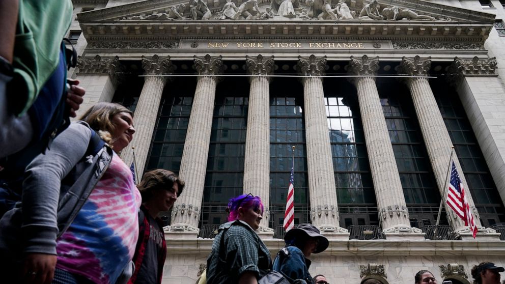 A tour group stops in front of the New York Stock Exchange in New York, Tuesday, June 14, 2022. Wall Street is wobbling between gains and losses Tuesday in its first trading after tumbling into a bear market on worries about a fragile economy and ris