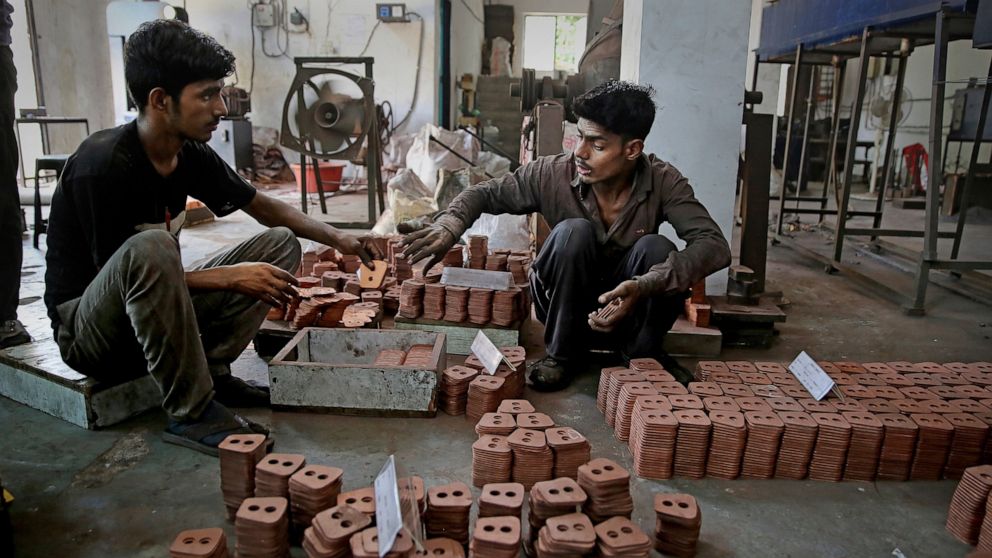 FILE - In this Sept. 5, 2019, file photo, Indian workers prepare packing of clutch buttons at an auto component manufacturing factory on the outskirts of New Delhi, India. Asian shares advanced Friday, Sept. 20, 2019, and India’s benchmark jumped 5.4