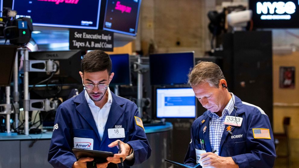 In this photo provided by the New York Stock Exchange, traders Orel Partush, left, and Robert Charmak work on the floor, Friday, June 10, 2022. Stocks on Wall Street fell sharply Friday after getting hammered by data showing inflation is getting wors