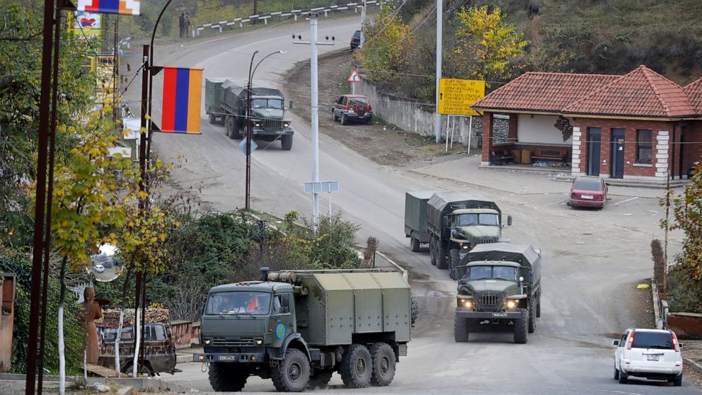 Russian peacekeepers' convoy drive through a street in Stepanakert, the separatist region of Nagorno-Karabakh, on Sunday, Nov. 15, 2020. Ethnic Armenian forces had controlled Nagorno-Karabakh and sizeable adjacent territories since the 1994 end of a 
