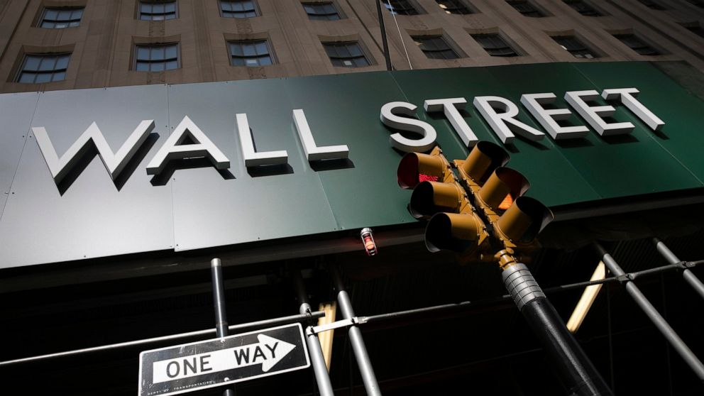 A sign for a Wall Street building is shown, Tuesday, June 16, 2020. Stocks are rising sharply in early trading on Wall Street after retail sales in the U.S. soared by a record 17.7% from April to May, double what economists were expecting and a welco