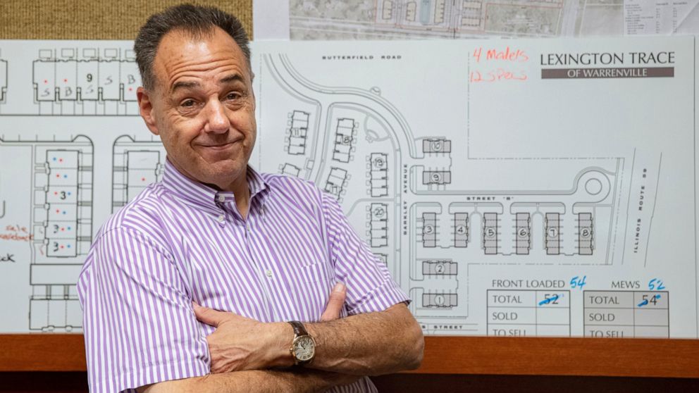 In this Tuesday, July 16, 2019 photo, Jeff Benach, co-owner of Lexington Homes poses for a portrait inside his office in Chicago. Lexington Homes, which has townhouse and single-family developments in the Chicago area, has been building smaller proje