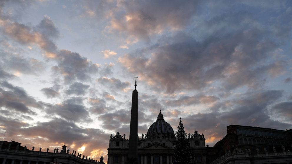 FILE - The sun sets behind St. Peter's Basilica, at the Vatican, Thursday, Dec. 5, 2019. The Vatican’s sprawling financial trial may not have produced any convictions yet or any new smoking guns. But recent testimony in May 2022 has provided plenty o