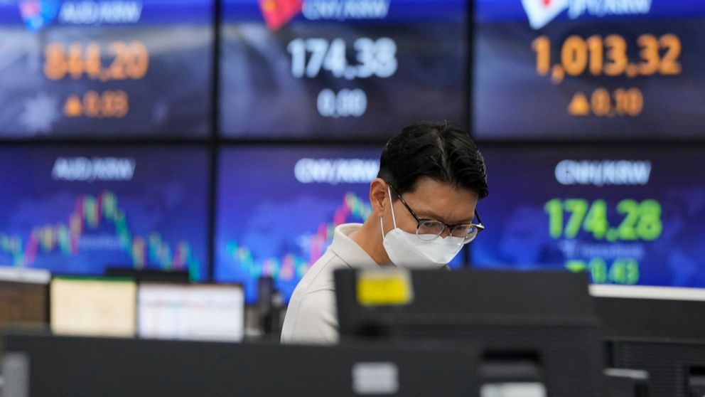 A currency trader watches monitors at the foreign exchange dealing room of the KEB Hana Bank headquarters in Seoul, South Korea, Thursday, July 1, 2021. Asian shares are mostly lower as investors await a much watched U.S. jobs for indications of how 