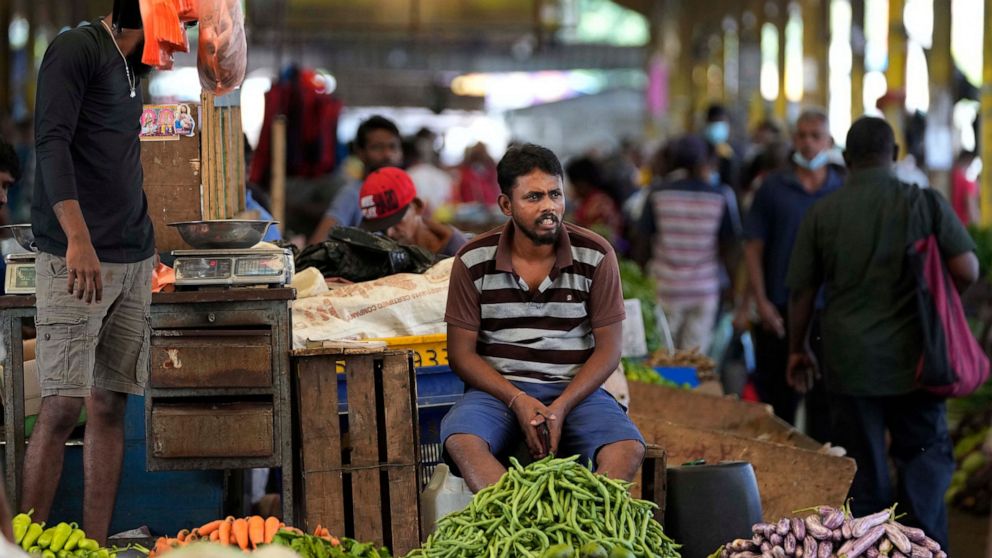 FILE - A vender waits for customers at a vegetable market place in Colombo, Sri Lanka, Friday, June 10, 2022. Some 1.6 billion people in 94 countries face at least one dimension of the crisis in food, energy and financial systems, according to a repo