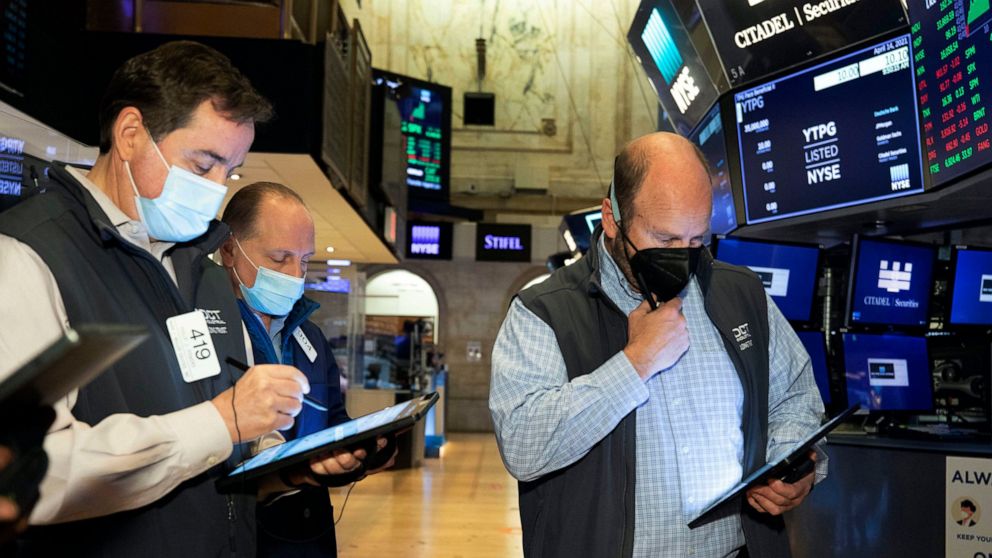 In this photo provided by the New York Stock Exchange, traders work on the floor, Wednesday April 14, 2021. U.S. stock indexes are tacking a bit more onto their record highs in midday trading Wednesday after big banks kicked off a highly anticipated 
