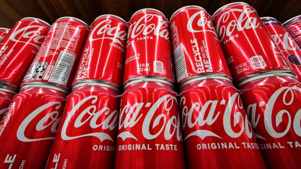 Cans of Coca-Cola are on display at a grocery market in Uniontown, Pa, on Sunday, April 24, 2022. Coca-Cola posted higher-than-expected sales in the second quarter, Tuesday, July 26, due to price increases and continuing improvement in demand at rest