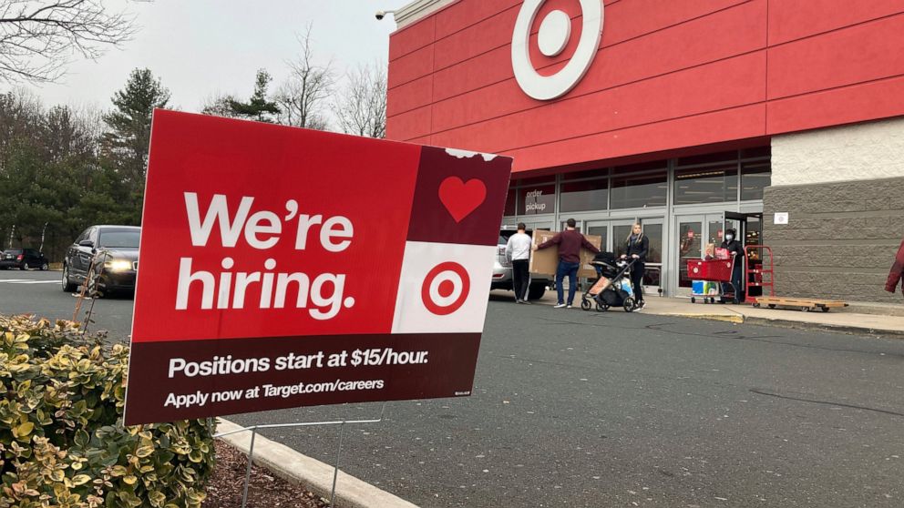 FILE - A hiring sign is in front of a Target store in Manchester, Conn., Nov. 39, 2021. Workers at Target stores and distribution centers in places like New York, where competition for finding and hiring staff is the fiercest, could see starting wage