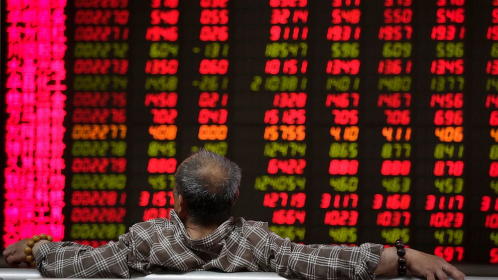 A man looks at an electronic board displaying stock prices at a brokerage house in Beijing, Wednesday, April 24, 2019. Shares were mostly lower in Asia on Wednesday despite the S&P 500’s all-time record high close the day before. (AP Photo/Andy Wong)