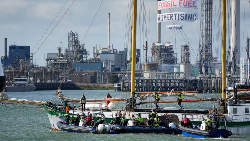 FILE- In this Monday, Oct. 4, 2021, file photo, Dutch riot police prepare to board Greenpeace's Beluga II when breaking up a protest by climate activists at a Shell refinery in Rotterdam, Netherlands. The Netherlands' biggest pension fund announced T